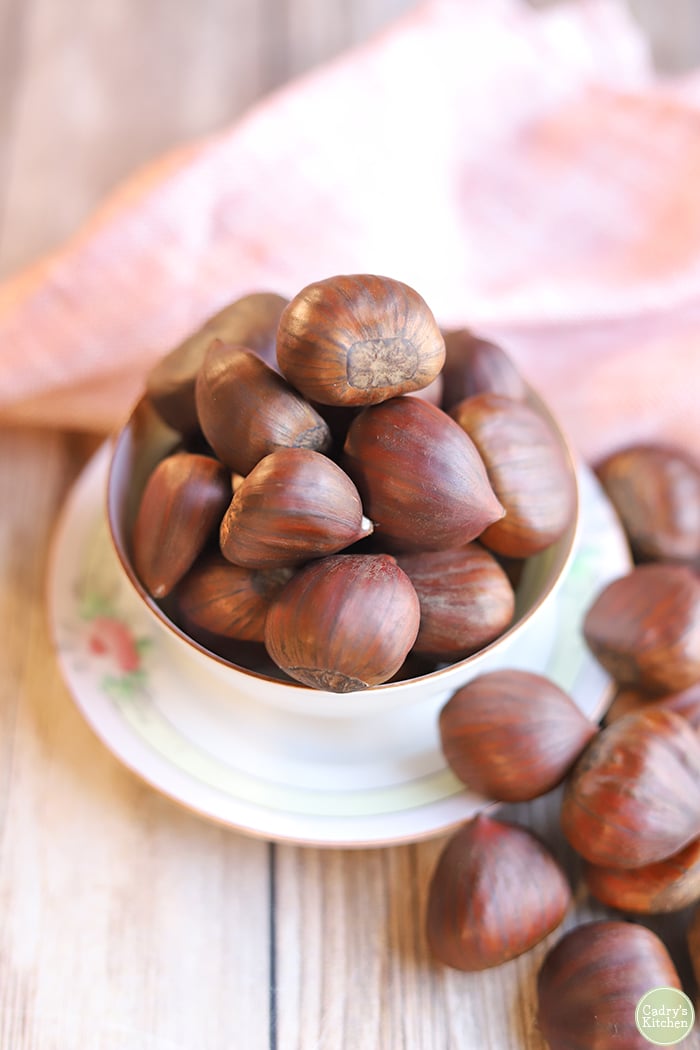 Italian chestnuts in a bowl with pink napkin.