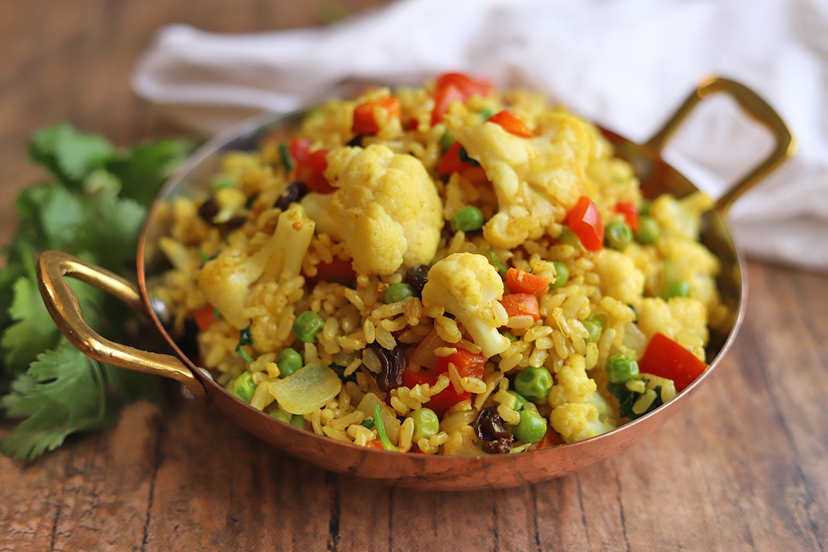 Ginger and turmeric rice in pan with vegetables.
