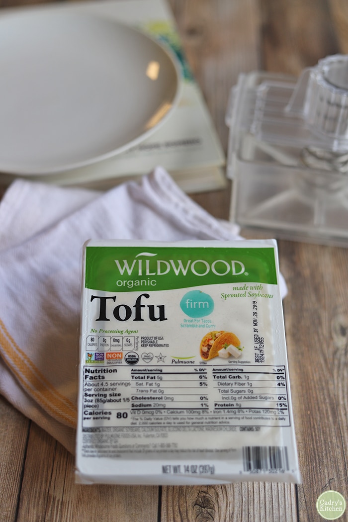 Wildwood tofu in package by towel & plate.