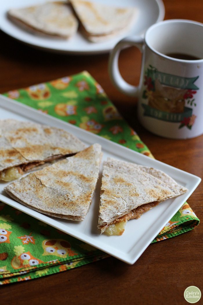 Toasted tortilla wedges with peanut butter and banana on owl napkin.