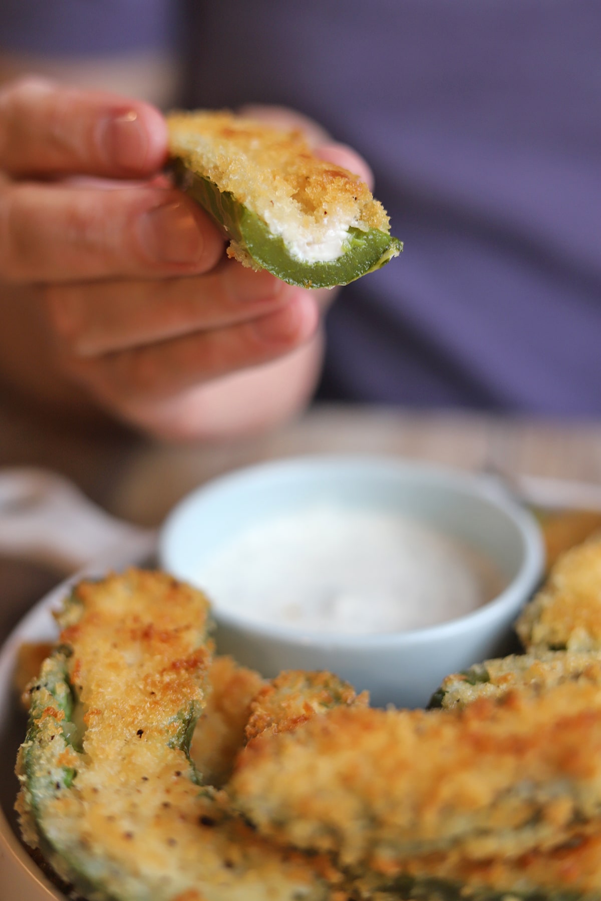 Cream cheese exposed in a breaded jalapeno popper.