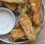 Text overlay: Vegan jalapeno poppers. Fried, air fried, or baked. Platter of poppers with dipping sauce.