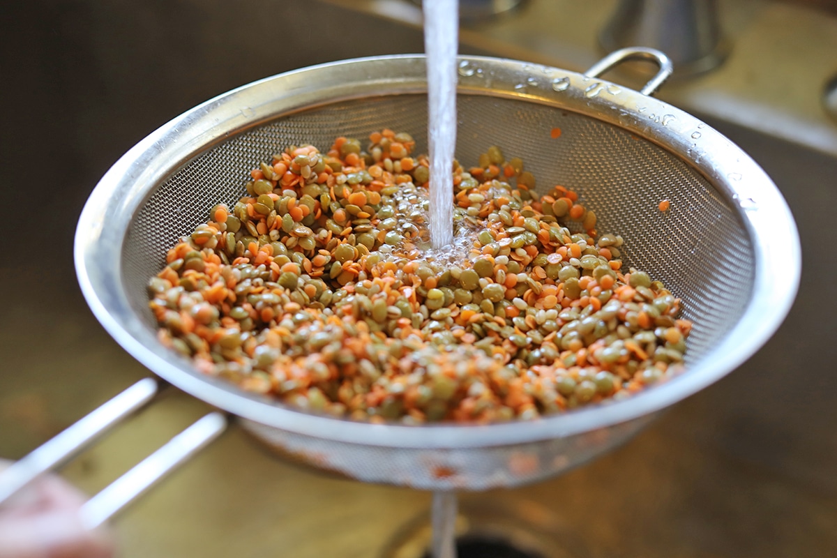 Rinsing lentils and barley in sieve.