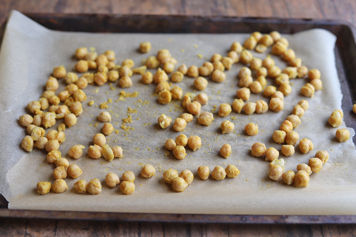 Chickpeas on a baking sheet with parchment paper.