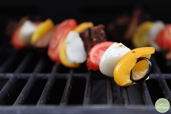 Grilled vegetable skewers on outdoor grill grate