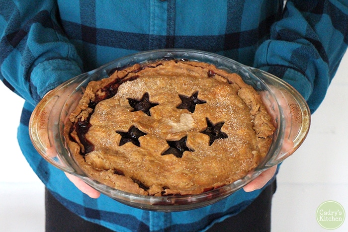 David holding fruit pie with star cut outs.