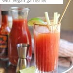 Text overlay: Bloody Mary with vegan garnishes. Cocktail on tray with ingredients.