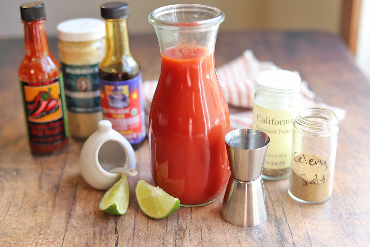 Ingredients for bloody mary drink: tomato juice, worcestershire, hot sauce, horseradish, salt, lime, vodka, pepper, and celery salt.