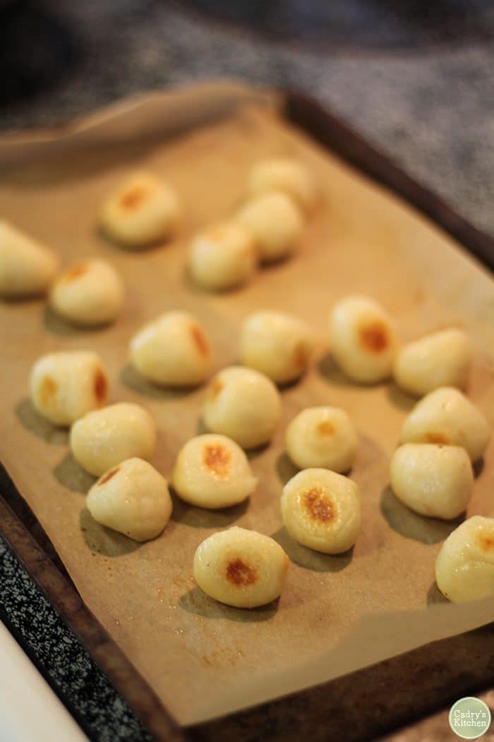 Roasted gnocchi on baking sheet.