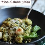 Roasted gnocchi with almond pesto in bowl. Plus text, "roasted gnocchi with almond pesto" and "vegan."