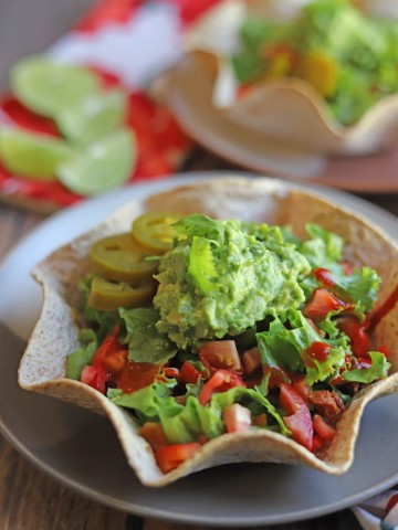 Close-up vegan taco salad with dollop of guacamole.