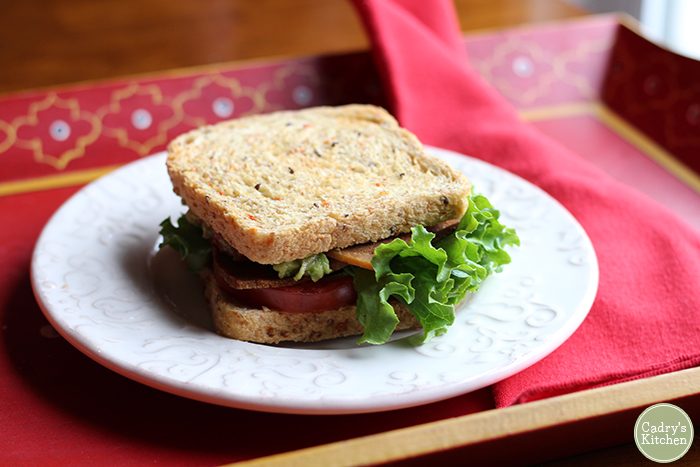 Vegan BLT on plate with red napkin.