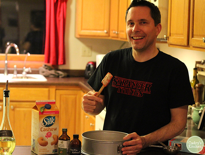 David holding spatula over cake pan.