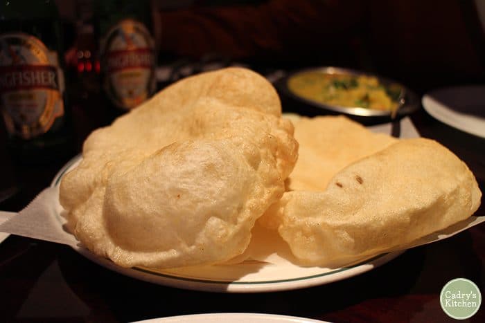 Puffy Indian poori on plate.