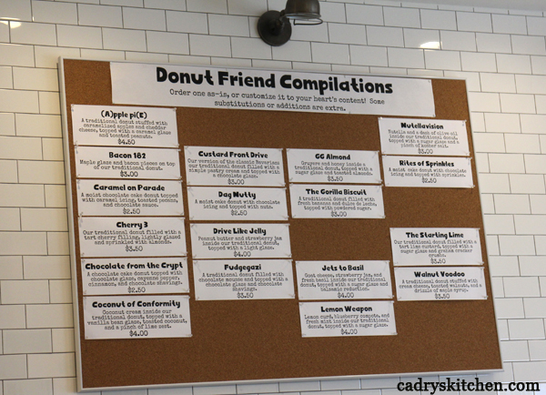 Donut Friend menu compilation on cork board.