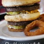 Text overlay: Should vegans eat at non-vegan restaurants? Burger on plate.