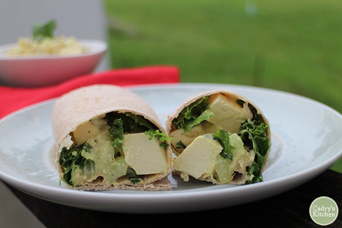 Eggless salad with kale in wrap on plate.