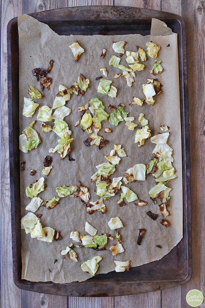 Roasted cabbage pieces on baking sheet.