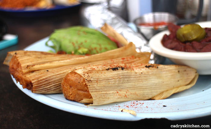 Close-up sweet potato pecan tamales on plate.