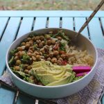 Salad with chickpeas, rice, and avocado in bowl.