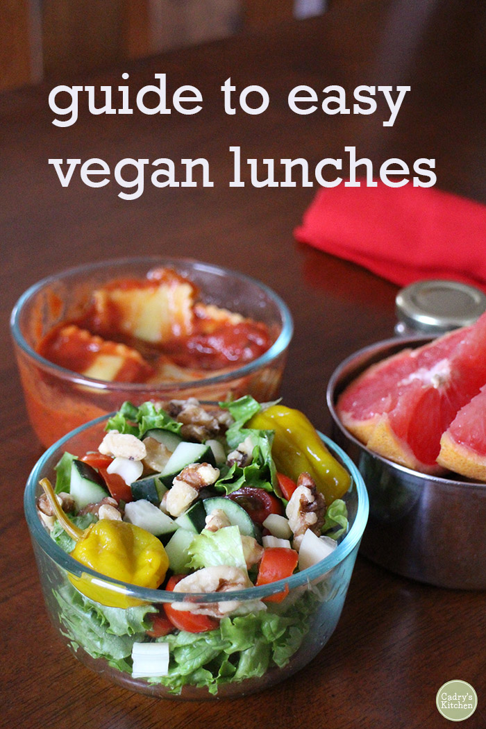 Text overlay: Guide to easy vegan lunches. Salad, ravioli, and grapefruit slices in to-go containers.