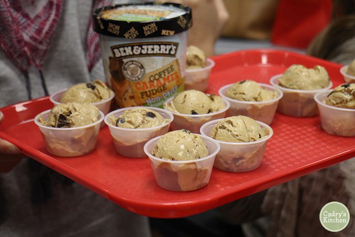 Ben and Jerry's vegan ice cream on red tray with container and cups.