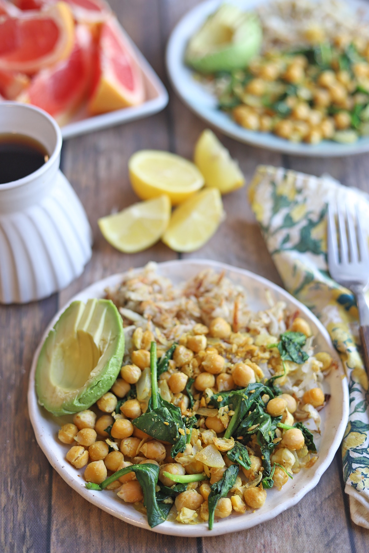 Chickpea scramble on plate with hashbrowns and avocado.