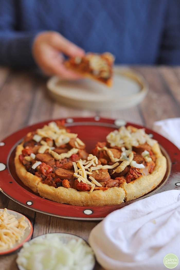 Chili dog pizza on platter.