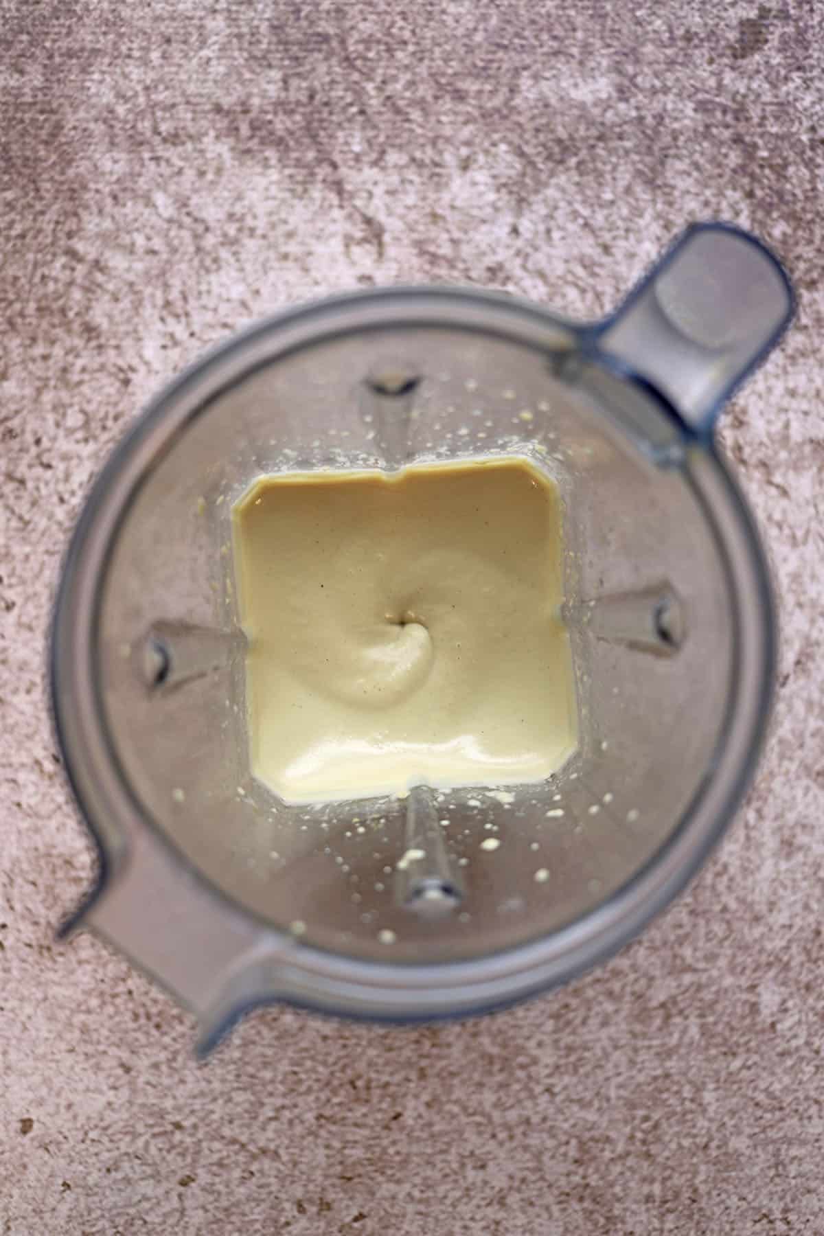 Blended cashew cream in blender pitcher.