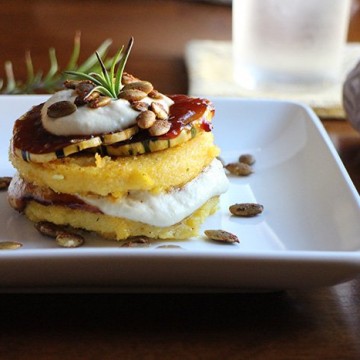 Polenta stack with cashew cream and barbecued squash on plate.