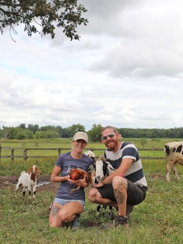 Shawn & Jered Camp standing with their rescued animal family at Iowa Farm Sanctuary.