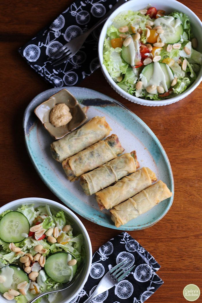 Overhead salads with peanuts and spring rolls with Chinese mustard.