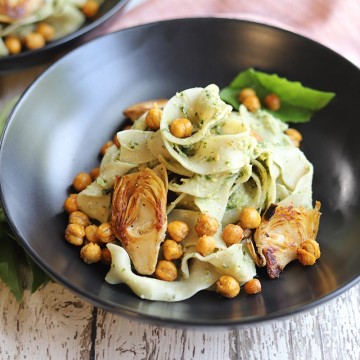 Bowl of vegan pesto pasta with artichokes.