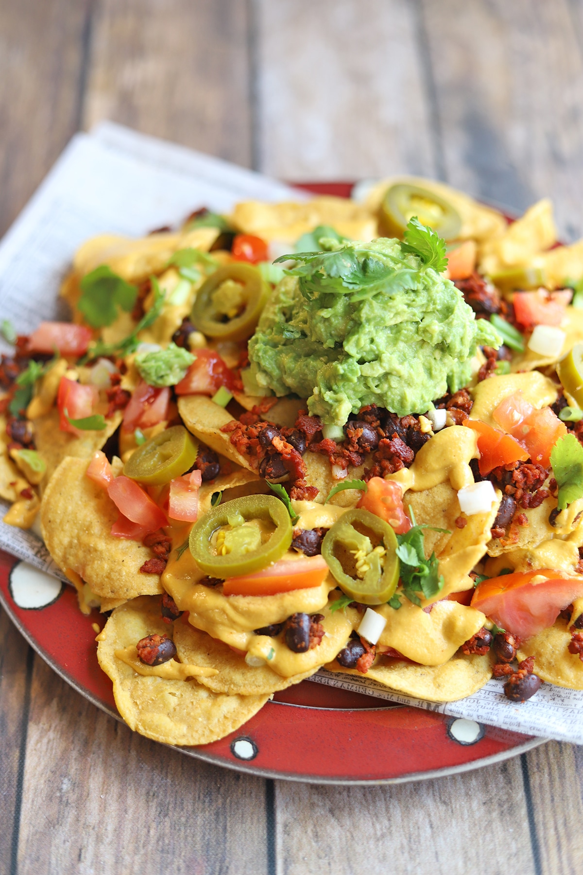 Close-up loaded nachos on table.