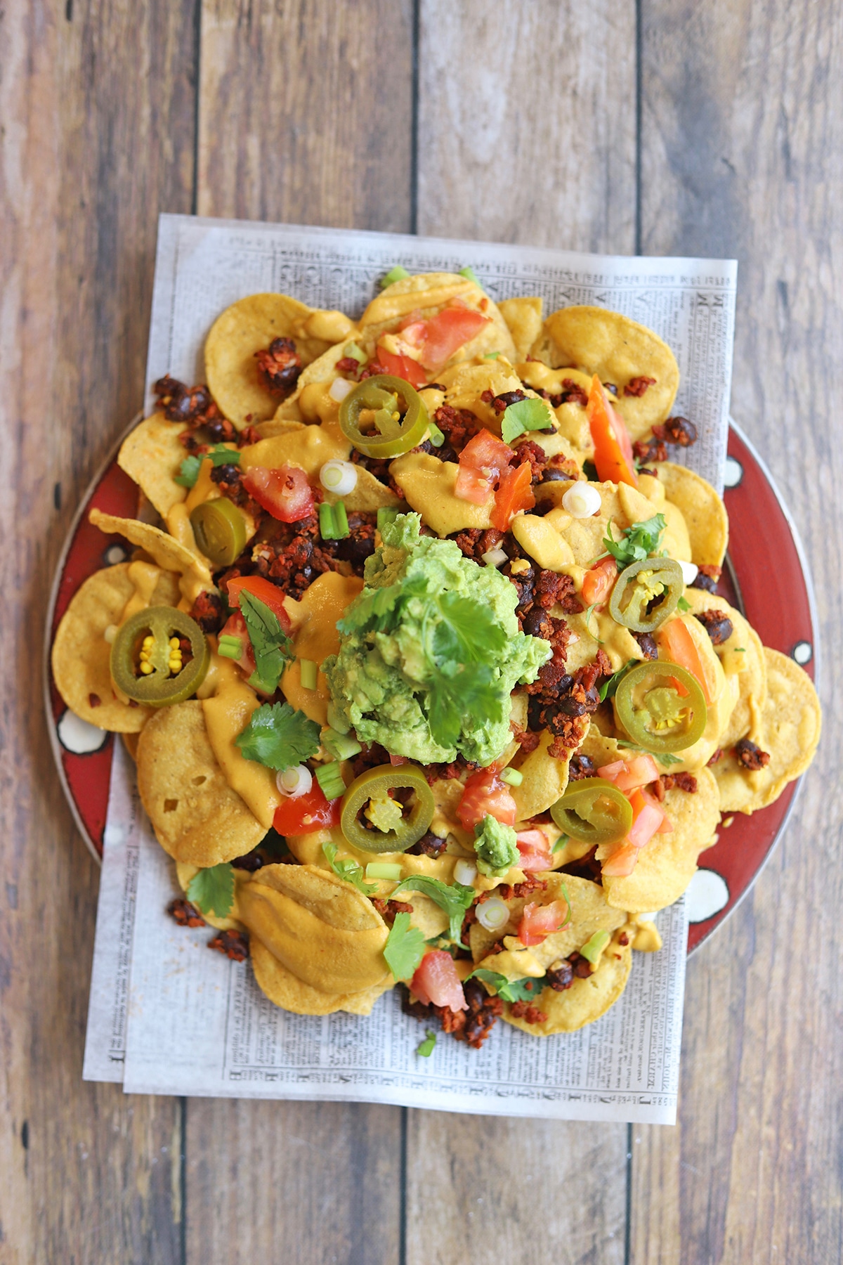 Overhead platter of nachos with cashew queso and guacamole.