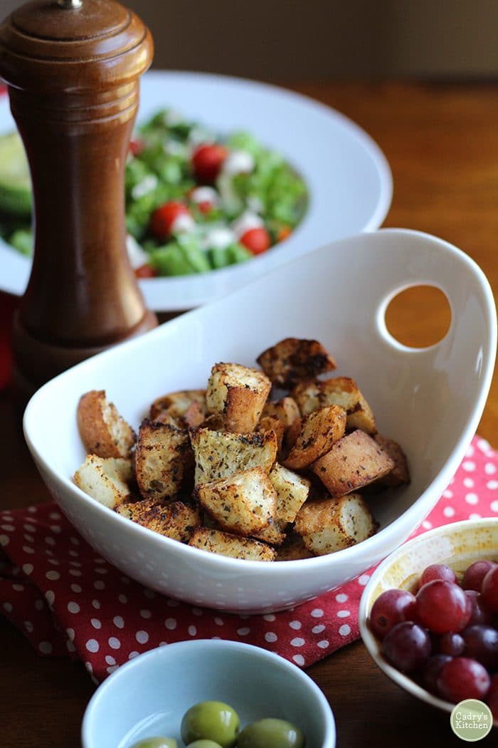 Croutons in a bowl on a polkadot napkin.