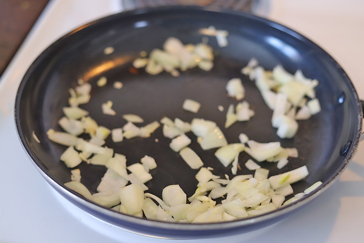 Onions and garlic sauteing in skillet.