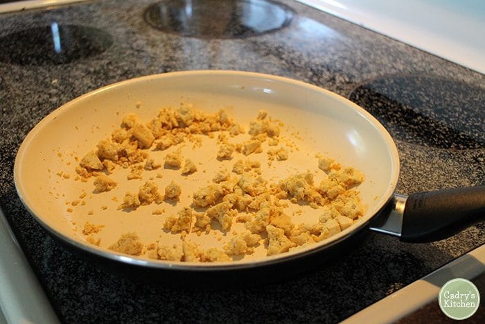 What do vegans eat? Easy tofu scramble in pan on stove.