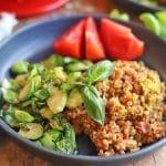 Plate with Brussels sprouts, tomatoes, and baked farro.