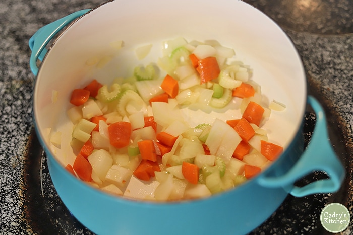 Celery, onions, carrot, and garlic sauteing in soup pot.
