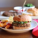 Vegan lentil burgers wiht chips, kale, and pasta sauce.