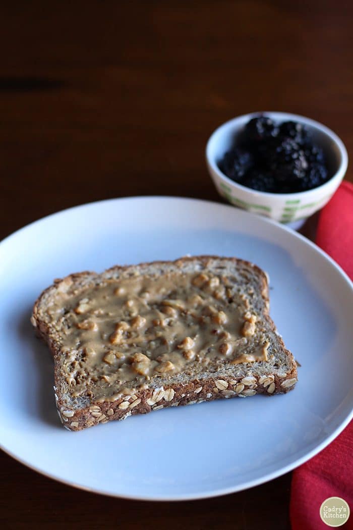 Peanut butter toast with blackberries.