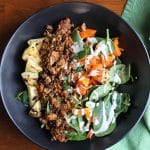 Jackfruit salad with grilled pineapple in black bowl.