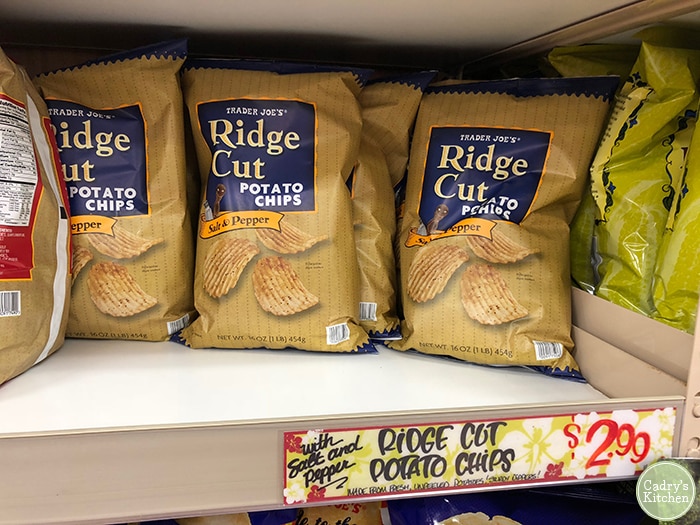 Bag of Trader Joe's ridge cut salt and pepper potato chips on shelf.
