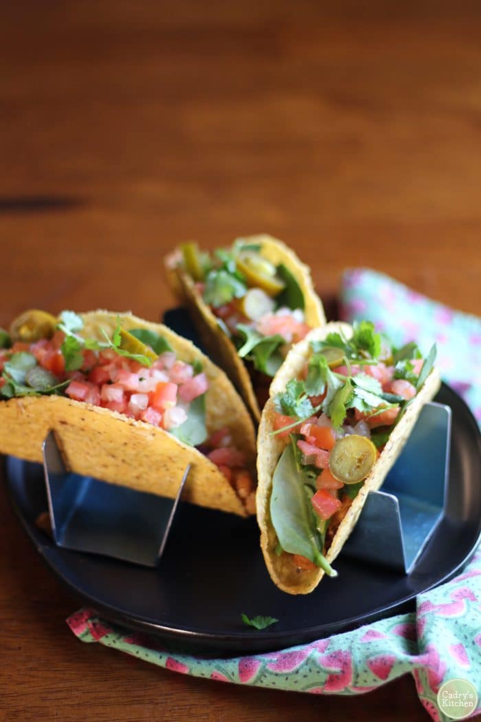 Chickpea tacos topped with spinach, cilantro, and pico de gallo.