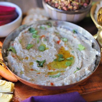 Eggplant dip in serving bowl by turnip pickles and carrots.