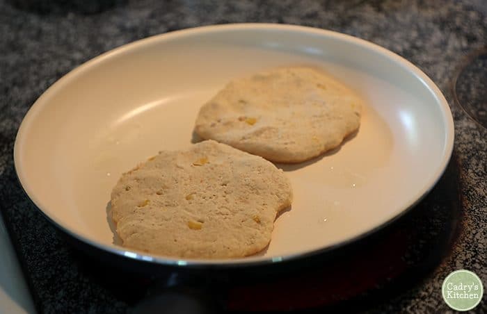 Vegan corn cakes made with masa flour in skillet.