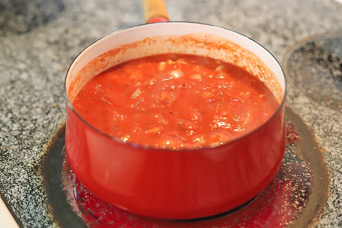 Vegan tomato soup in pot on stove.
