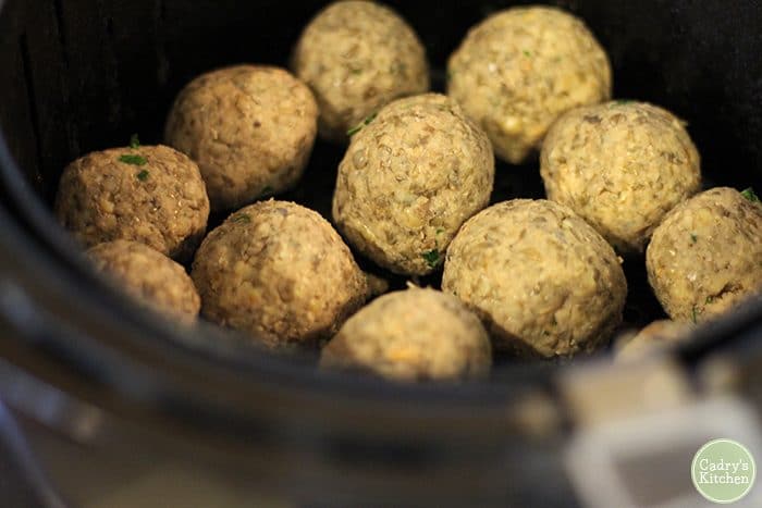 Uncooked lentil balls in air fryer.