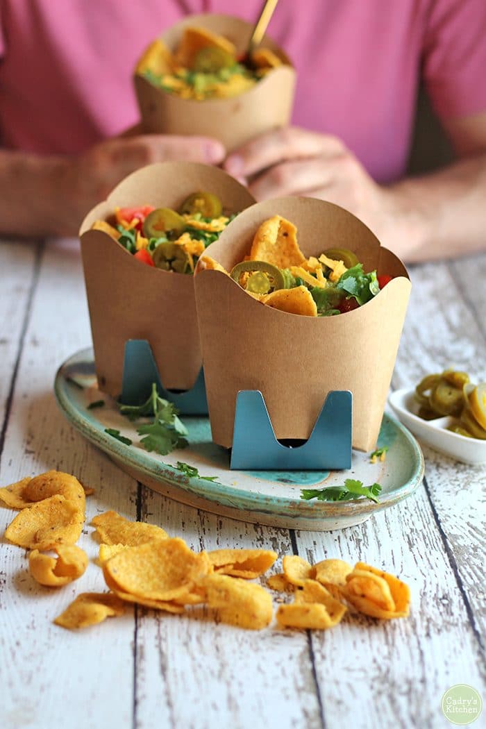 Vegan walking tacos in containers with corn chips.